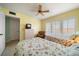 Bright bedroom with twin beds, ceiling fan, shuttered windows, and tile flooring at 343 Rex Pl # G, Madeira Beach, FL 33708