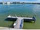 A private boat dock is set up for a relaxing day with white chairs and an easy water access ramp at 343 Rex Pl # G, Madeira Beach, FL 33708