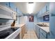 Compact kitchen with white appliances, blue cabinets, and ample counter space at 343 Rex Pl # G, Madeira Beach, FL 33708