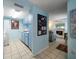 Galley kitchen with light blue cabinets, white appliances, and tile floors at 343 Rex Pl # G, Madeira Beach, FL 33708