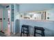 Kitchen pass-through with barstool seating, adjacent to dining and living area at 343 Rex Pl # G, Madeira Beach, FL 33708