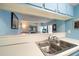 Kitchen pass-through offers views into the living room with fireplace and ample sunlight at 343 Rex Pl # G, Madeira Beach, FL 33708