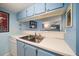 A kitchen pass-through provides a convenient way to serve meals at 343 Rex Pl # G, Madeira Beach, FL 33708
