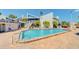 Large swimming pool with lounge chairs for relaxing in the sun at 343 Rex Pl # G, Madeira Beach, FL 33708