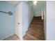 Carpeted stairs lead to the upper level with convenient under-stair closet at 343 Rex Pl # G, Madeira Beach, FL 33708