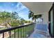 Enjoy the outdoors from this balcony with a seating area and views of lush landscaping and the community pool at 400 Island Way # 201, Clearwater Beach, FL 33767