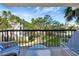 A relaxing balcony view with outdoor seating overlooking lush landscaped gardens at 400 Island Way # 201, Clearwater Beach, FL 33767
