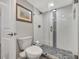 Updated bathroom with a toilet, glass shower, and modern fixtures under recessed lighting at 400 Island Way # 201, Clearwater Beach, FL 33767