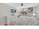Bedroom with bright windows, ceiling fan and a large dresser with wall mounted tv at 400 Island Way # 201, Clearwater Beach, FL 33767