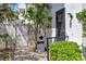 Exterior view of building with trash bin, utility door, bushes and partial fence at 400 Island Way # 201, Clearwater Beach, FL 33767