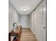 A clean, bright hallway featuring sleek flooring, closet space, and a console table at 400 Island Way # 201, Clearwater Beach, FL 33767