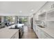 Bright, modern kitchen with white cabinetry, stainless steel appliances, and a seamless connection to the balcony at 400 Island Way # 201, Clearwater Beach, FL 33767