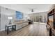 Comfortable living room with a ceiling fan and balcony access, filled with natural light and modern decor at 400 Island Way # 201, Clearwater Beach, FL 33767