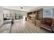 A comfortable living room featuring a large TV, modern furniture, and floor-to-ceiling windows at 400 Island Way # 201, Clearwater Beach, FL 33767