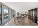 Open floor plan featuring a dining area and living space with large windows and balcony access at 400 Island Way # 201, Clearwater Beach, FL 33767