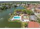 Aerial view showcasing a community pool, bocce ball court, and waterfront recreational amenities at 4027 Davit Dr, New Port Richey, FL 34652