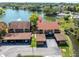 Aerial view of property overlooking a tranquil lake with lush surroundings at 4027 Davit Dr, New Port Richey, FL 34652