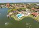 Aerial view showcasing a community pool, bocce ball court, and waterfront recreational amenities at 4027 Davit Dr, New Port Richey, FL 34652