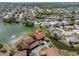 Aerial view showcasing homes nestled around a tranquil lake in a lush neighborhood at 4027 Davit Dr, New Port Richey, FL 34652