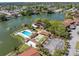 Aerial view showcasing a community pool, bocce ball court, and waterfront recreational amenities at 4027 Davit Dr, New Port Richey, FL 34652