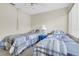 Comfortable bedroom features two twin beds, a ceiling fan, and a window offering plenty of natural light at 4027 Davit Dr, New Port Richey, FL 34652