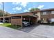 Assigned carport parking with well-maintained landscaping and a well-lit drive at 4027 Davit Dr, New Port Richey, FL 34652