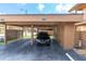 Carport with a black car parked underneath, wooden supports, and the number 4027 displayed at 4027 Davit Dr, New Port Richey, FL 34652