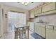 Functional kitchen featuring light-colored cabinetry and ample counter space at 4027 Davit Dr, New Port Richey, FL 34652