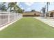 Community lawn with palm trees and a white picket fence offers a relaxing outdoor space at 4027 Davit Dr, New Port Richey, FL 34652
