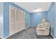 Bright living room featuring soft carpeting, two armchairs and closet at 4027 Davit Dr, New Port Richey, FL 34652