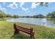Picturesque view of the pond with bench seating and fountain water feature at 4027 Davit Dr, New Port Richey, FL 34652