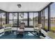 Relaxing sunroom with wicker chairs, carpeted floors, and serene lake views at 4027 Davit Dr, New Port Richey, FL 34652
