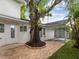 Enchanting backyard with paver patio and majestic tree, perfect for relaxation at 445 33Rd N Ave, St Petersburg, FL 33704
