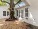 Backyard with paver patio and beautiful big tree, creating a peaceful outdoor space at 445 33Rd N Ave, St Petersburg, FL 33704