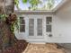 Paver patio in the backyard with view of french doors and large tree at 445 33Rd N Ave, St Petersburg, FL 33704