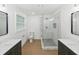 Bright bathroom with glass shower, dual vanities and updated fixtures at 445 33Rd N Ave, St Petersburg, FL 33704