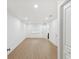 Spacious bedroom with wood floors, neutral walls, base trim, and a modern ceiling light at 445 33Rd N Ave, St Petersburg, FL 33704