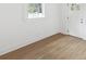Freshly painted entryway with a wood-look floor, white trim, and natural light at 445 33Rd N Ave, St Petersburg, FL 33704