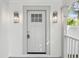 Close-up of the front door with decorative sconces and hardware at 445 33Rd N Ave, St Petersburg, FL 33704