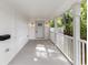 Covered front porch with white railing, sconce lighting, and space for relaxing at 445 33Rd N Ave, St Petersburg, FL 33704