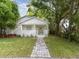 Inviting home exterior featuring a brick walkway, front porch, and lush landscaping at 445 33Rd N Ave, St Petersburg, FL 33704
