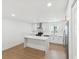 Modern kitchen boasts white cabinets, island and stainless steel appliances at 445 33Rd N Ave, St Petersburg, FL 33704