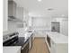 Bright kitchen offers stainless appliances, white cabinets and a large island at 445 33Rd N Ave, St Petersburg, FL 33704