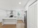 Gorgeous kitchen features white cabinets, stainless appliances and quartz countertops at 445 33Rd N Ave, St Petersburg, FL 33704