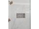 Marble shower with glass enclosure, bronze fixtures and tiled storage at 445 33Rd N Ave, St Petersburg, FL 33704