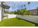 Secluded backyard space with artificial grass and surrounded by white walls, offering a serene outdoor retreat at 4515 W North A St # 8, Tampa, FL 33609
