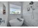 Bathroom featuring a standalone tub with marble tile and sleek chrome fixtures at 4515 W North A St # 8, Tampa, FL 33609