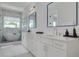 A gorgeous bathroom featuring dual sinks, marble countertops, and a glass shower at 4515 W North A St # 8, Tampa, FL 33609