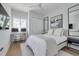 Bright bedroom featuring modern decor, a comfortable bed, and a dedicated workspace with dual monitors at 4515 W North A St # 8, Tampa, FL 33609