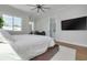 Primary bedroom with a large bed, ceiling fan, and en-suite bathroom at 4515 W North A St # 8, Tampa, FL 33609